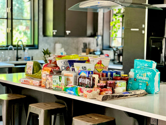 Grocery Shopping done and delivered before you arrive to your vacation rental. Groceries stacked neatly on a kitchen counter of an Airbnb. 